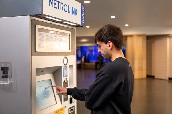 Customer using a Metrolink ticket machine.
