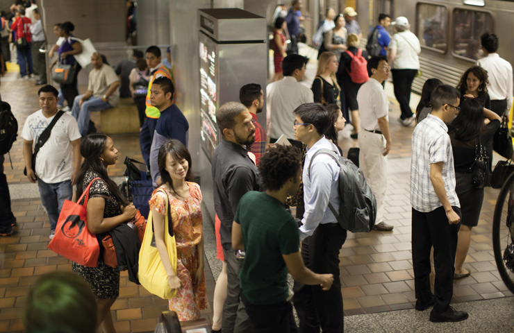 A group of riders waiting together to ride the subway