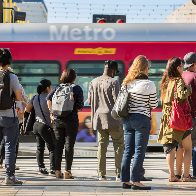A group of riders waiting to ride the bus